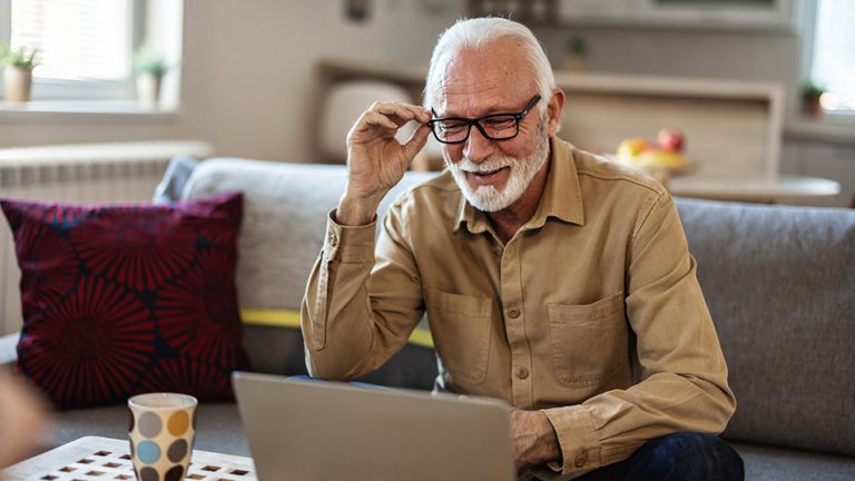 Man sat at computer wondering about"Refractive lens exchange vs. cataract surgery"